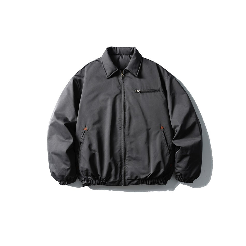 Dark gray padded bomber jacket, front view, with pointed collar, front zipper, chest zip pocket and elastic hem