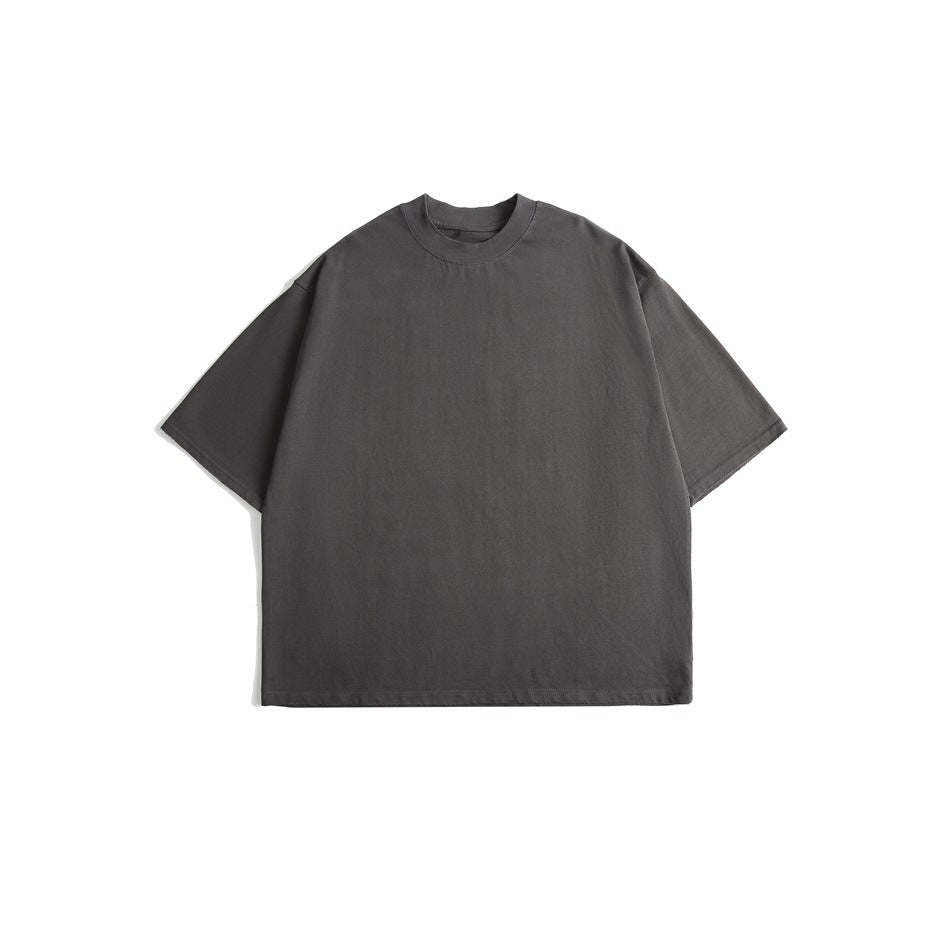 Front view of a plain charcoal gray oversized short-sleeve crew-neck T-shirt on a white background.