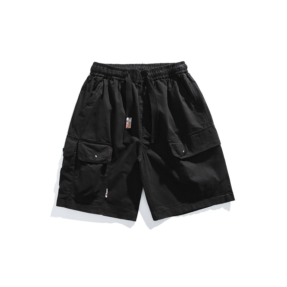 Black cargo shorts flat lay with elastic drawstring waist and snap flap cargo pockets