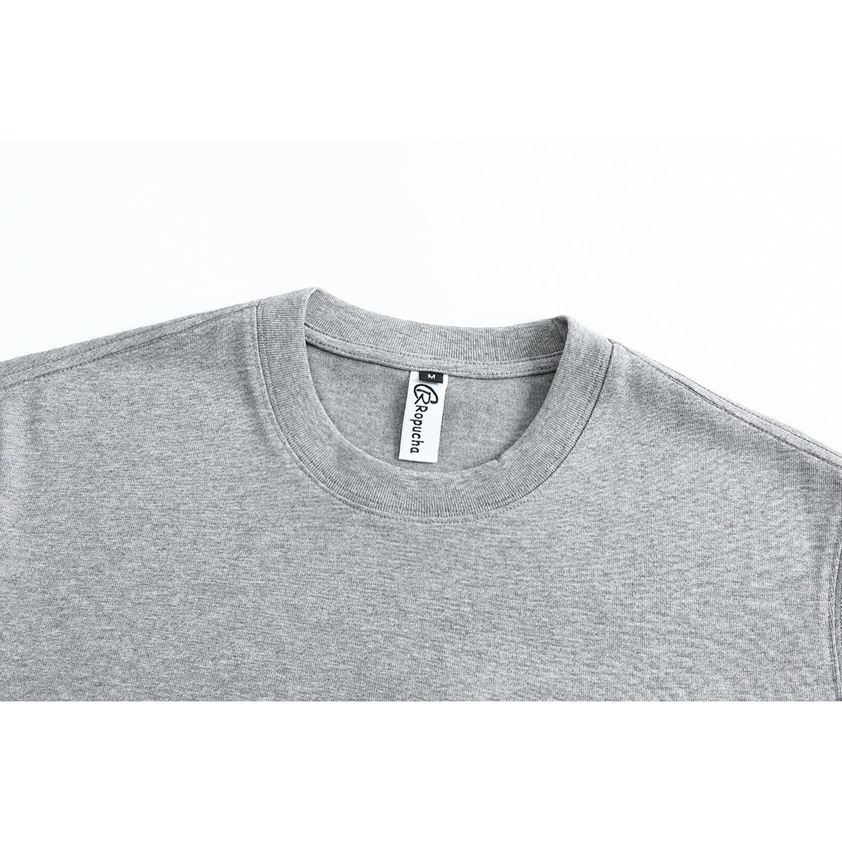 Close-up of a gray T-shirt's ribbed crew neck and sewn-in neck label.