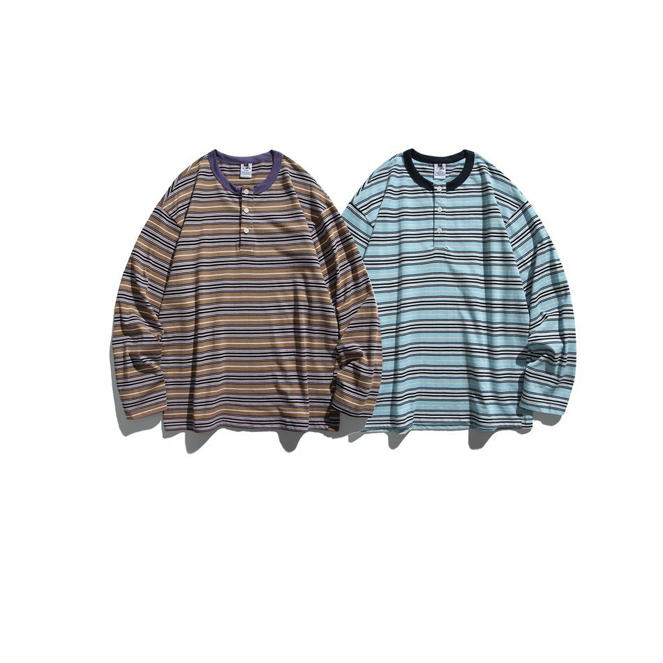 Two flat-laid striped long-sleeve henleys: one tan with a lavender collar and one light blue with a dark collar.