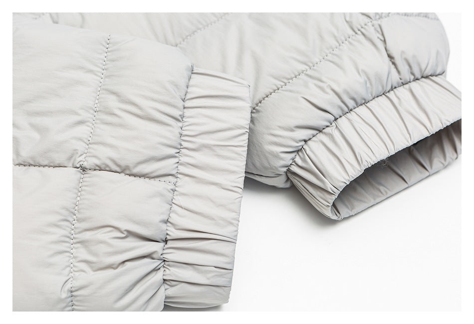 Close-up of the light gray jacket's quilted sleeve and gathered elastic cuff.