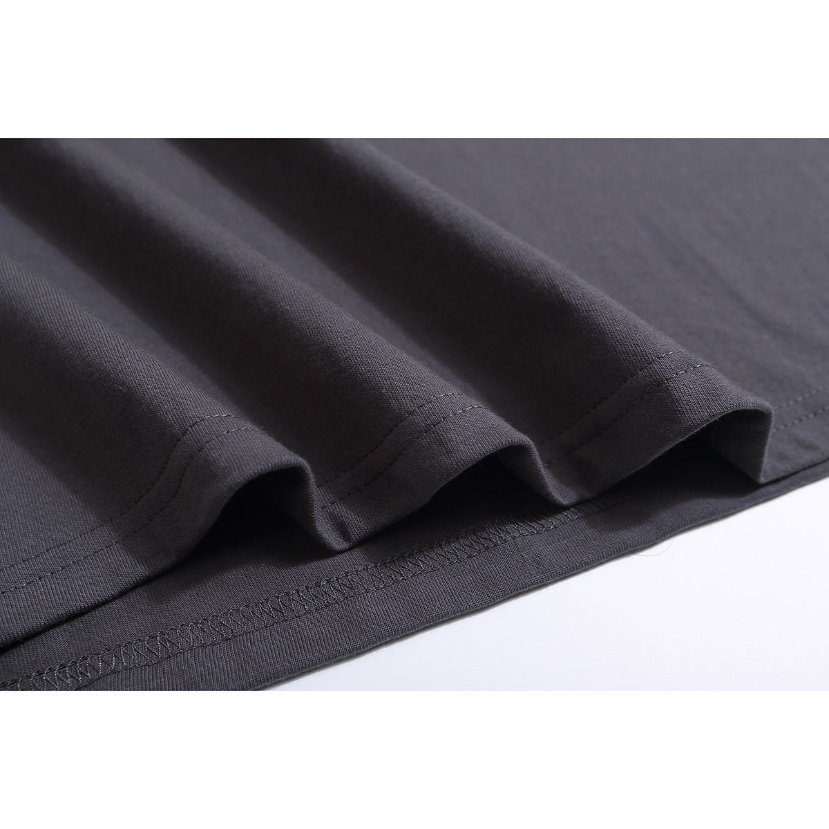 Close-up of the charcoal-gray T-shirt’s folded hem and stitching.