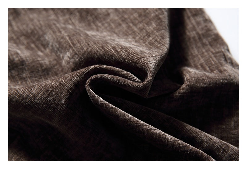 Close-up of dark brown textured fabric draped in soft folds.
