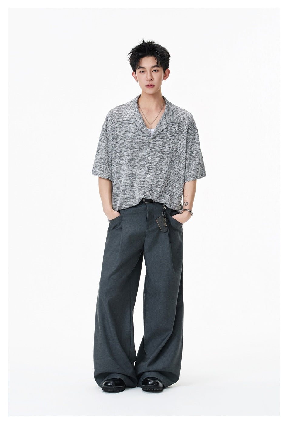 Full-length view of a model wearing a gray marled short-sleeve button-front shirt with a notched collar.