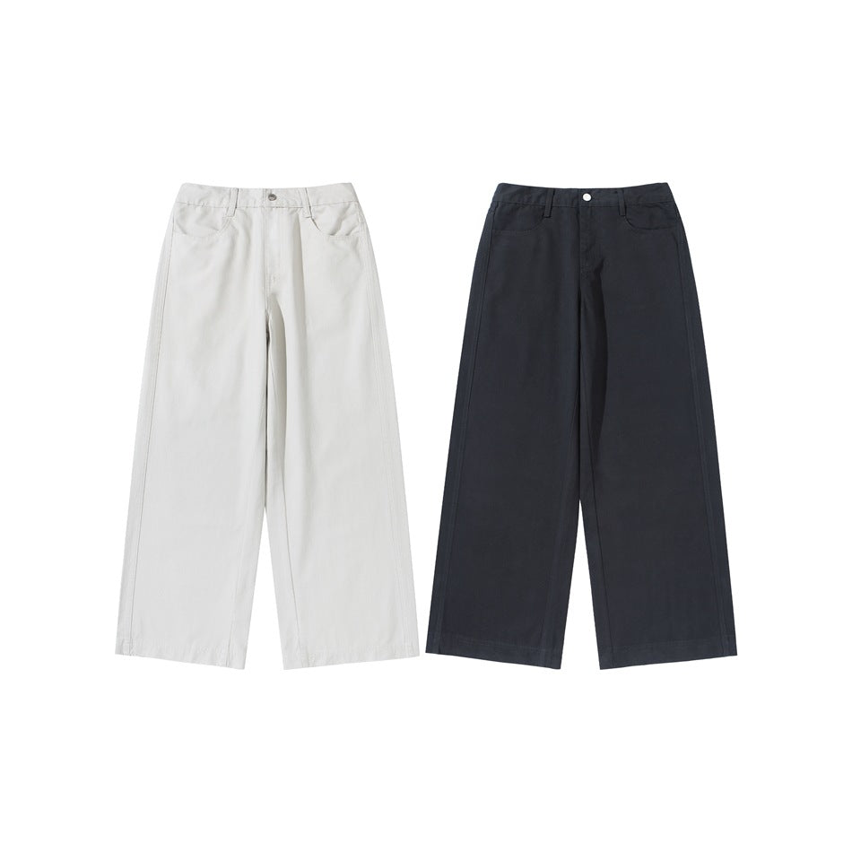 Front views of wide-leg trousers in ivory and dark charcoal, shown side by side.