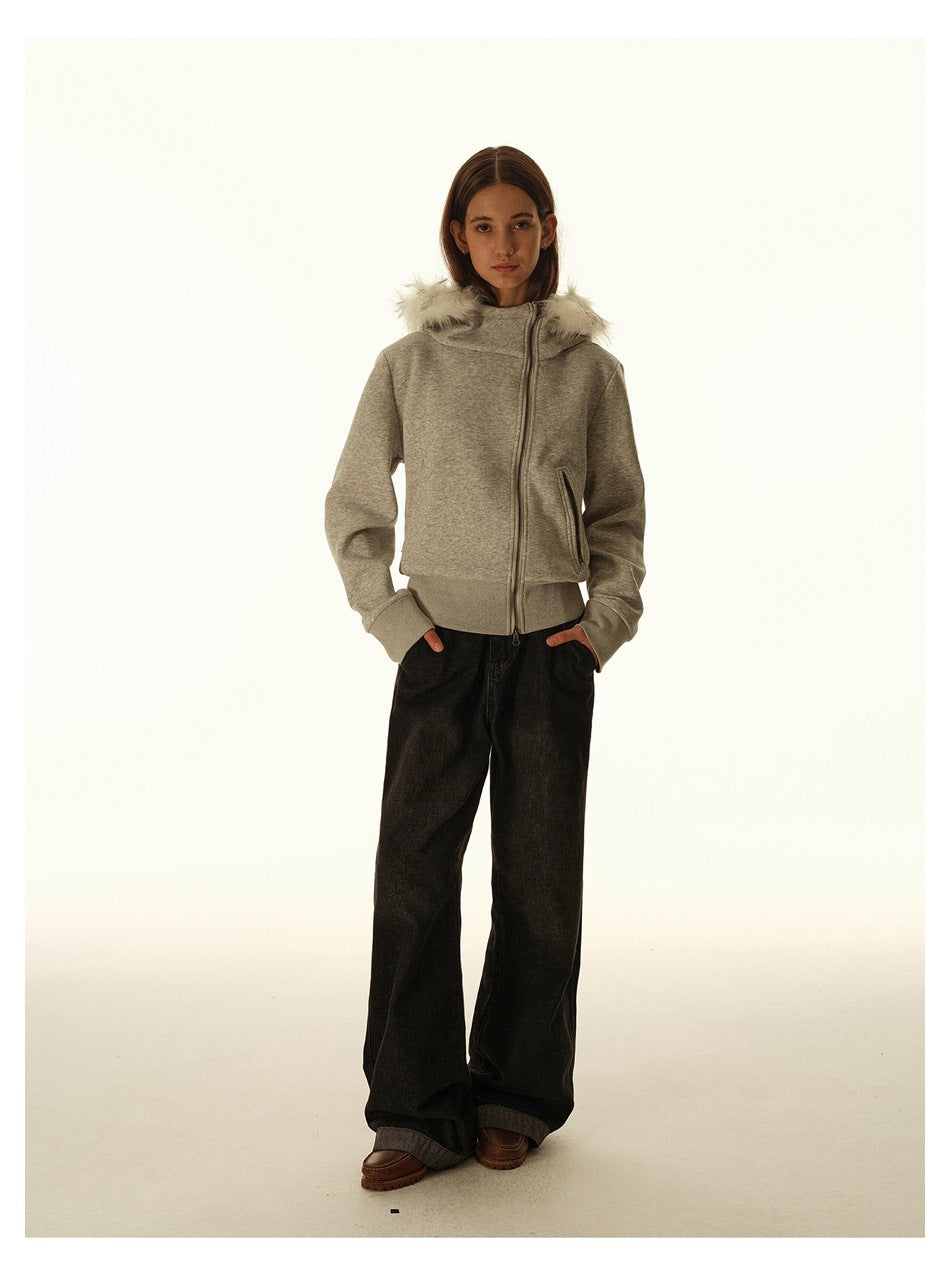 Full-length model wearing a light gray zip-front jacket with a white fur-trimmed hood and wide black pants.