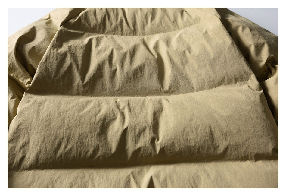 Close-up of the khaki jacket back, showing its broad horizontal stitched panels.