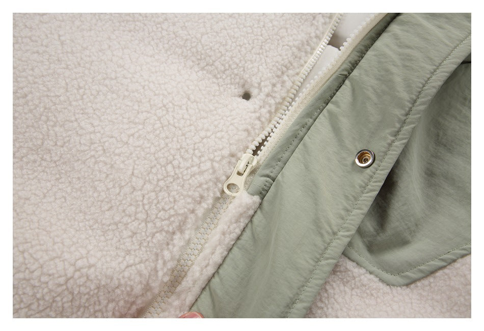 Close-up of a sage green jacket's zipper, snap, and cream sherpa lining.