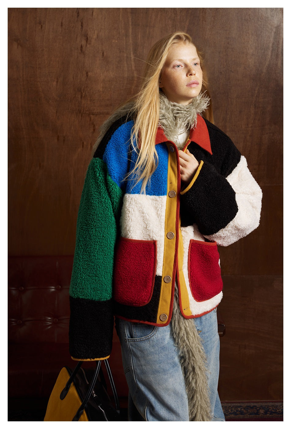 Model wearing a color-block button-front jacket with red pockets, shown from the front.