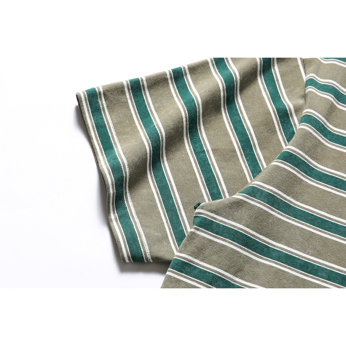 Close-up of the short sleeve and striped fabric of a khaki and dark green T-shirt.