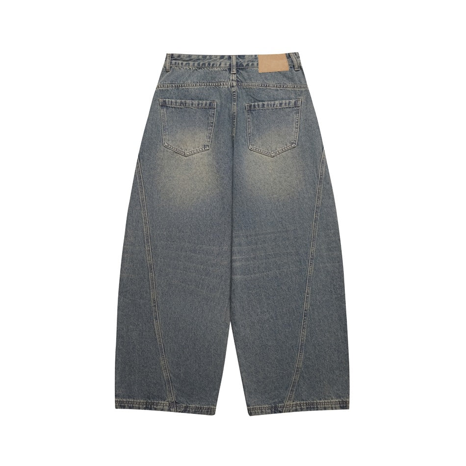 Back view of faded blue wide-leg jeans with two rear pockets and a plain tan waistband patch.