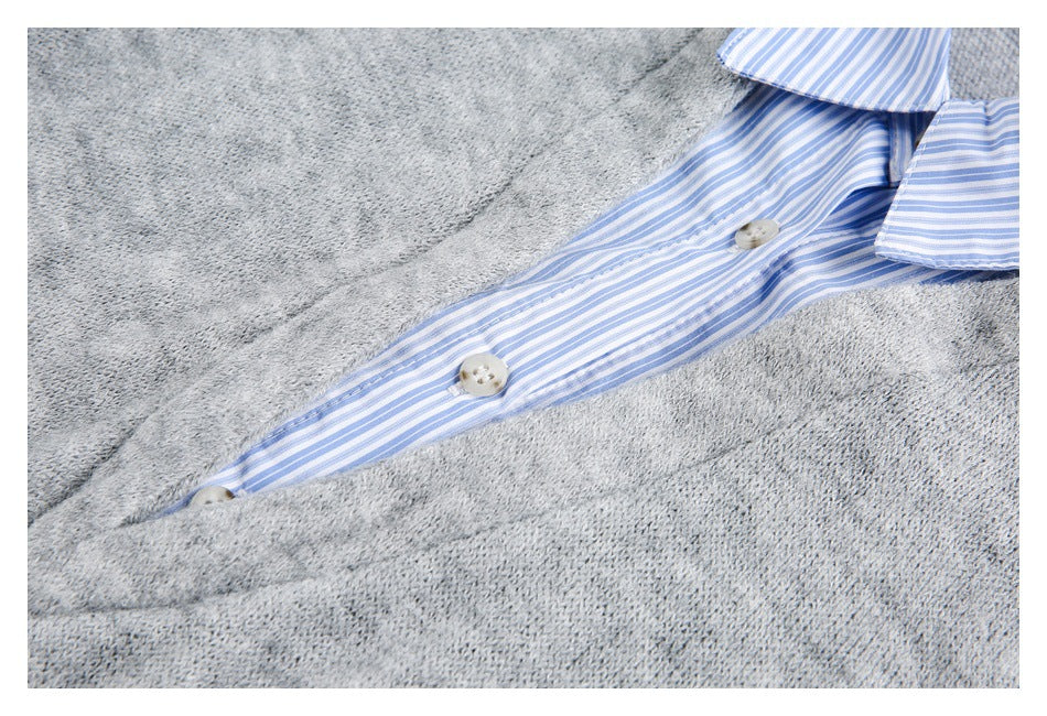 Close-up of a gray knit top's blue-and-white striped button placket and collar.