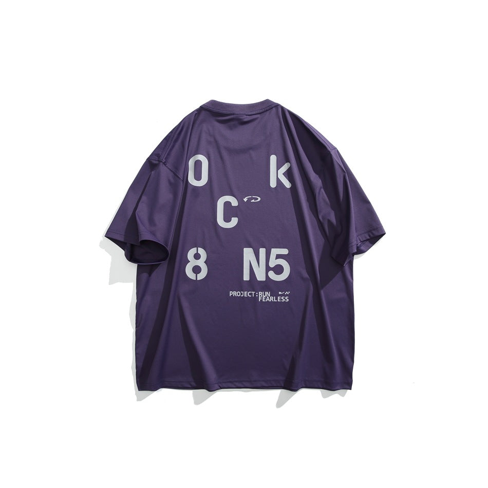 Back of purple short-sleeve T-shirt with large gray stencil letter and number graphic