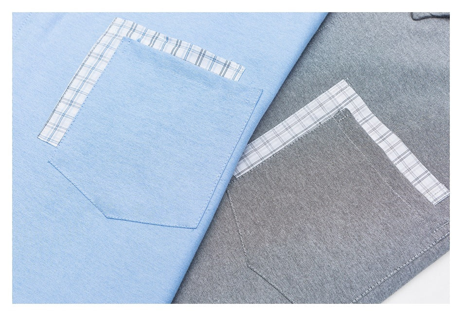 Close-up of blue and gray shirt pockets, each with a narrow plaid fabric trim.