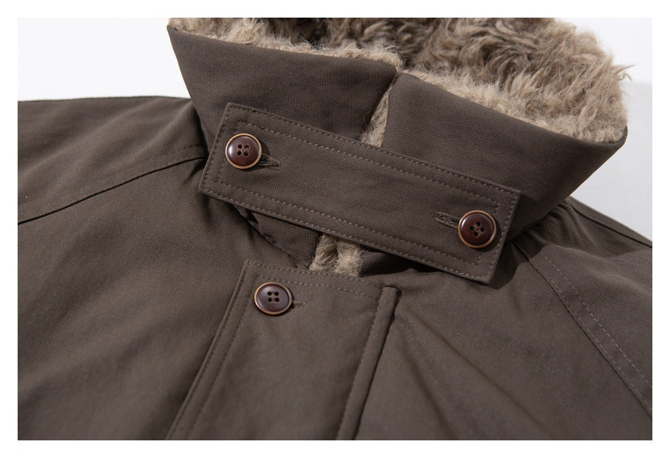 Close-up of a dark brown coat collar with plush lining, buttoned throat tab, and front buttons.