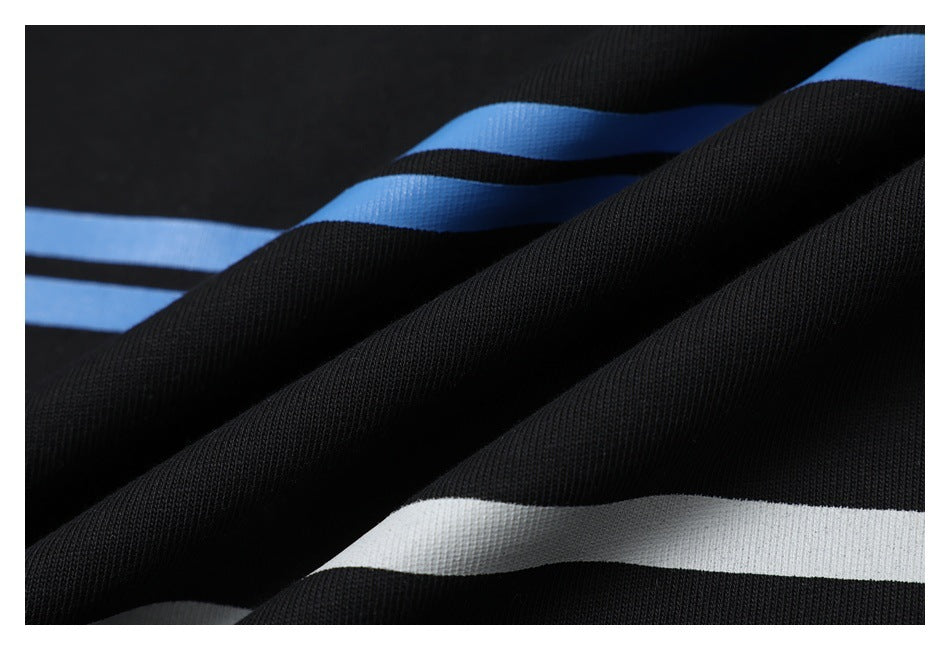 Close-up of gathered black fabric with blue and white stripe details.