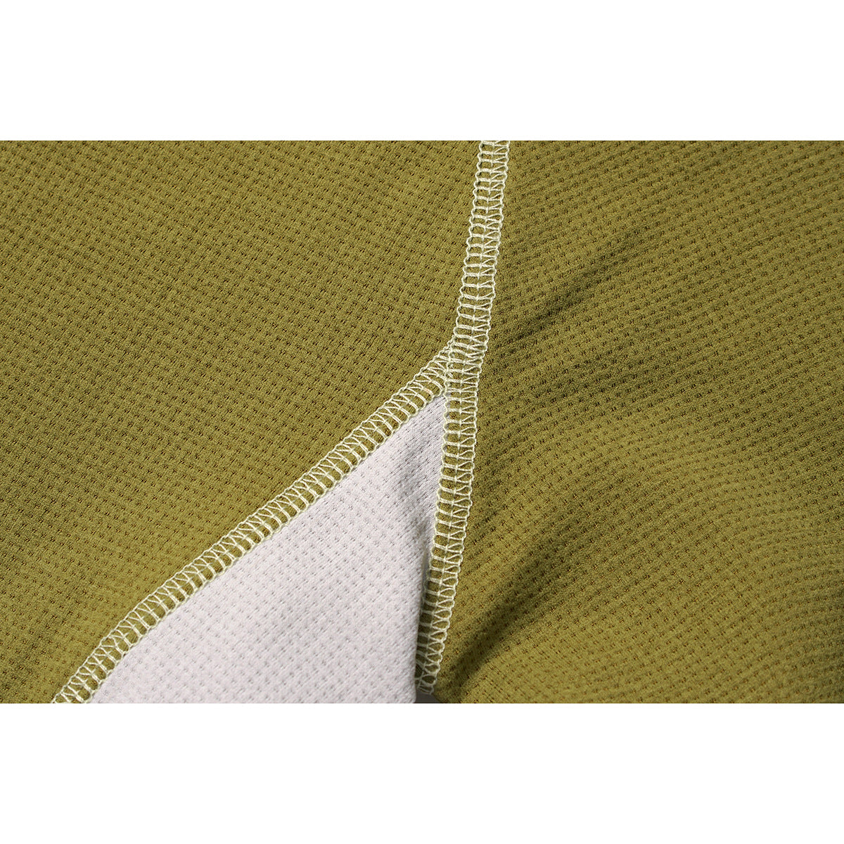 Close-up of an olive top's white mesh panel and contrasting overlocked seam.