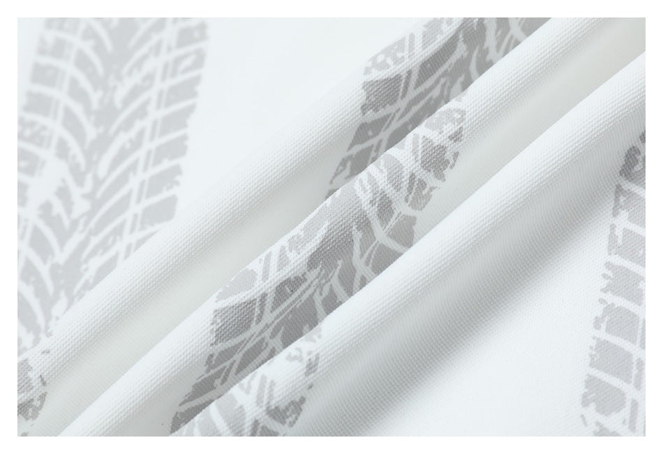 Close-up of white shirt fabric with a light gray tire-track pattern and folded ridges.