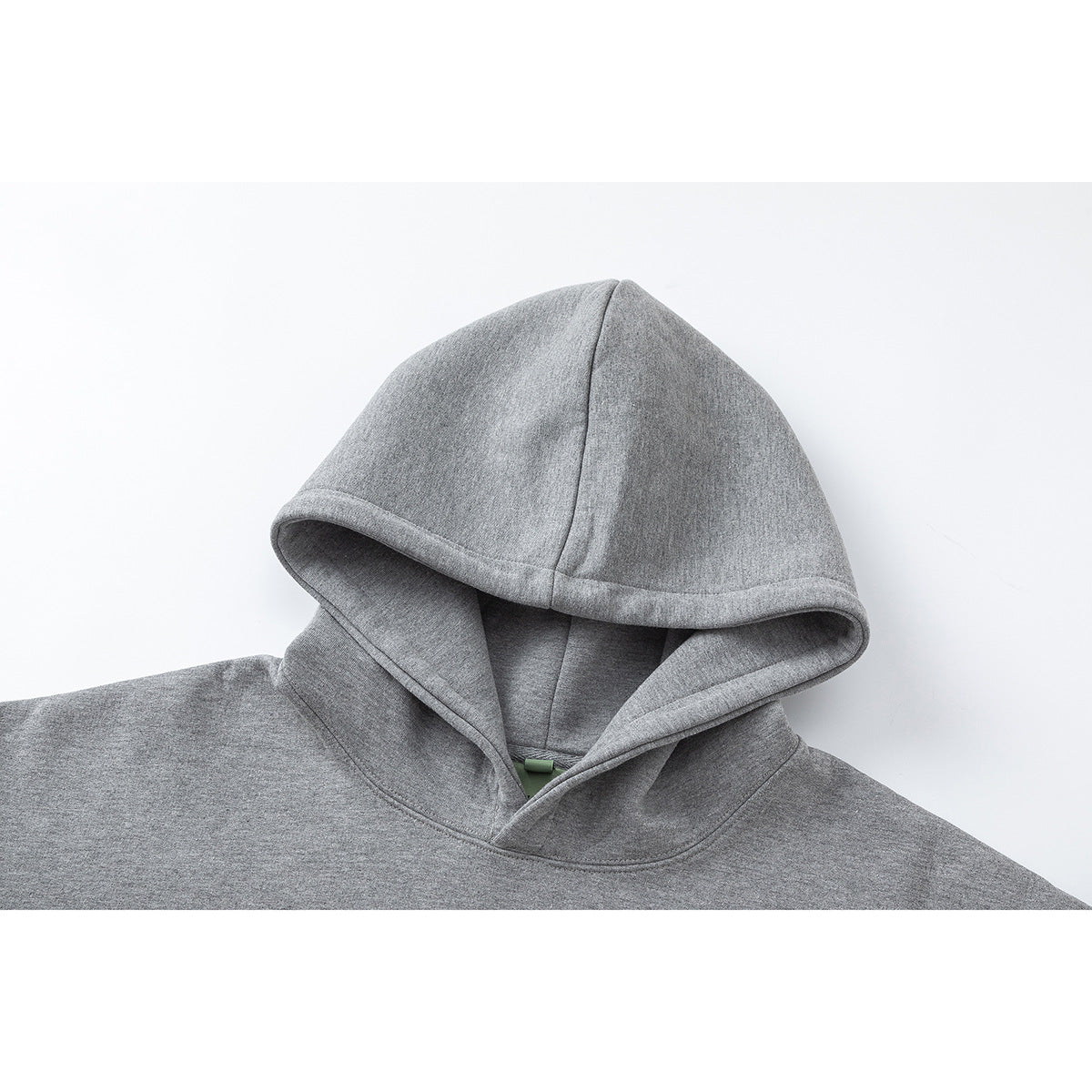 Close-up of a heather gray hoodie showing its large lined hood and stitched neckline.