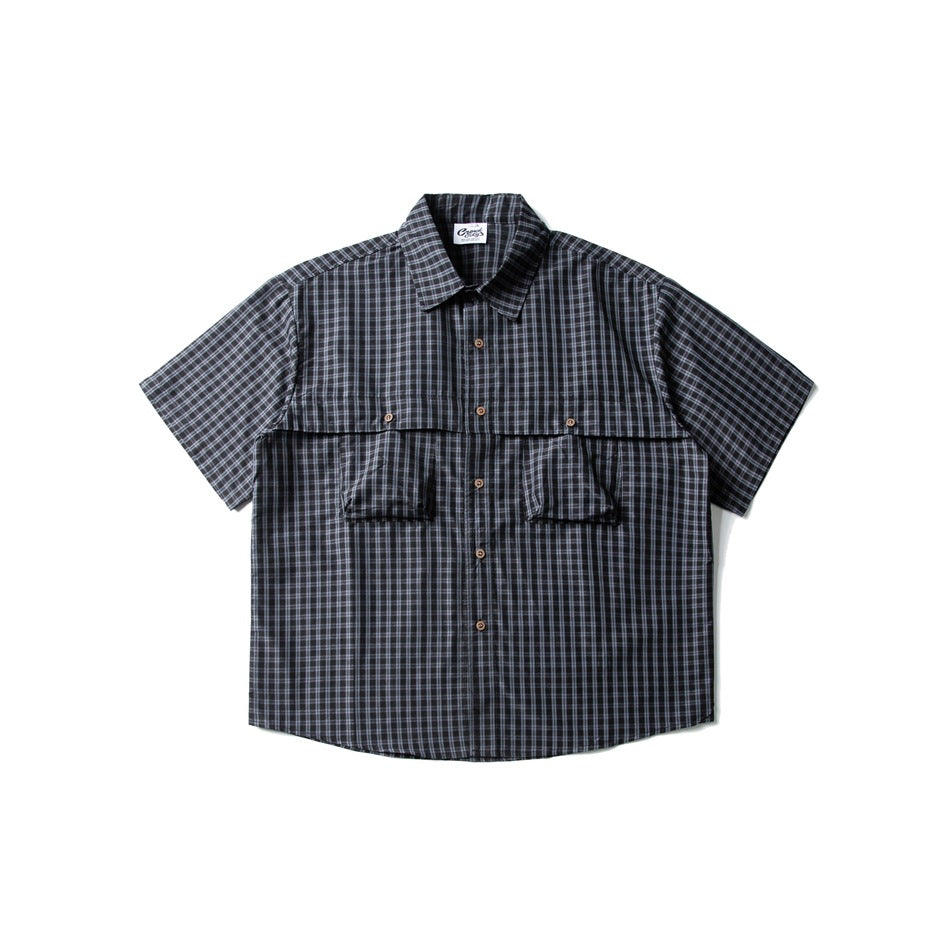 Ink blue small-check short-sleeve button-up shirt with two chest flap pockets, flat lay front view