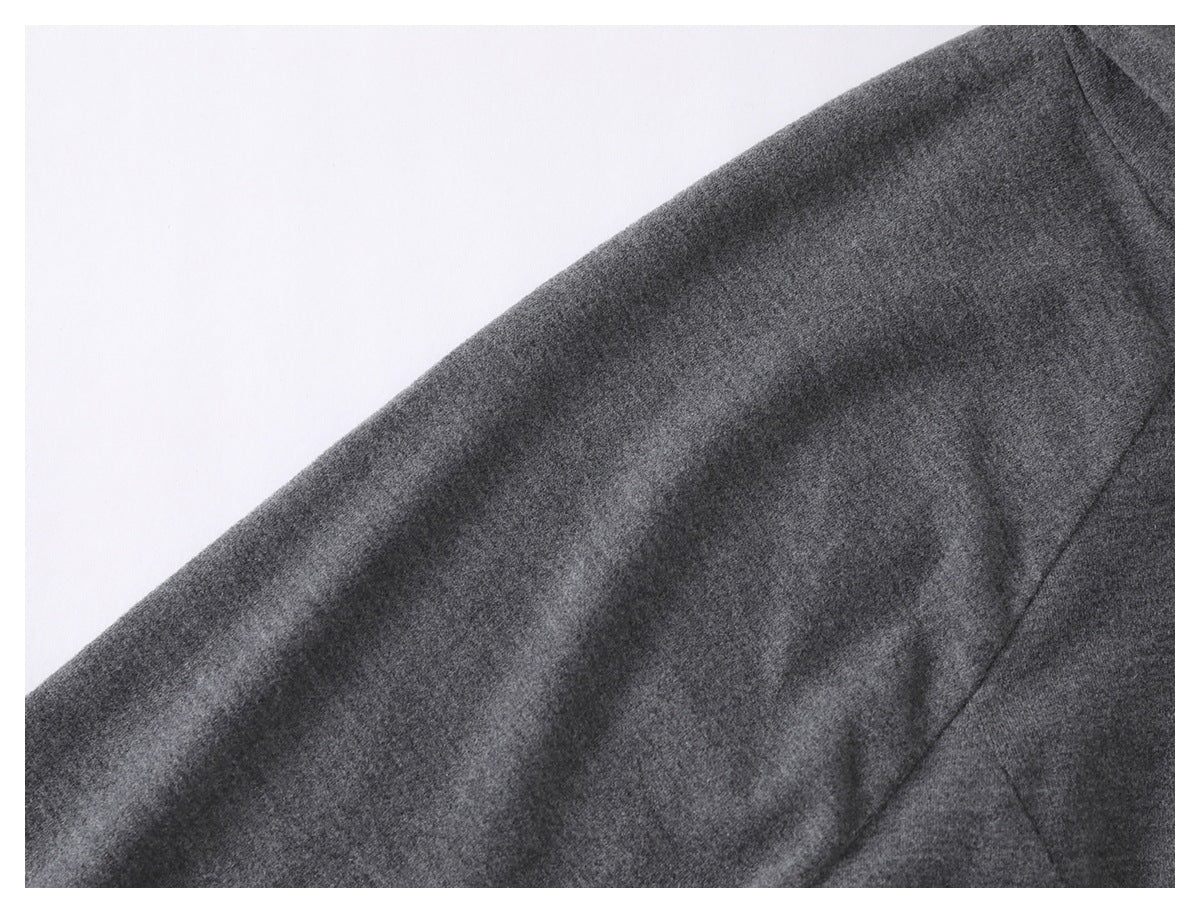 Close-up of the charcoal gray garment's soft-looking surface and curved seam.