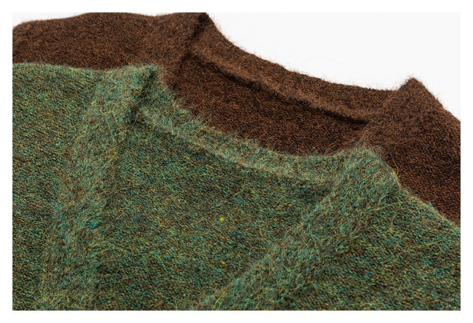 Close-up of a teal and brown fuzzy knit sweater, with the teal section overlapping brown knit.