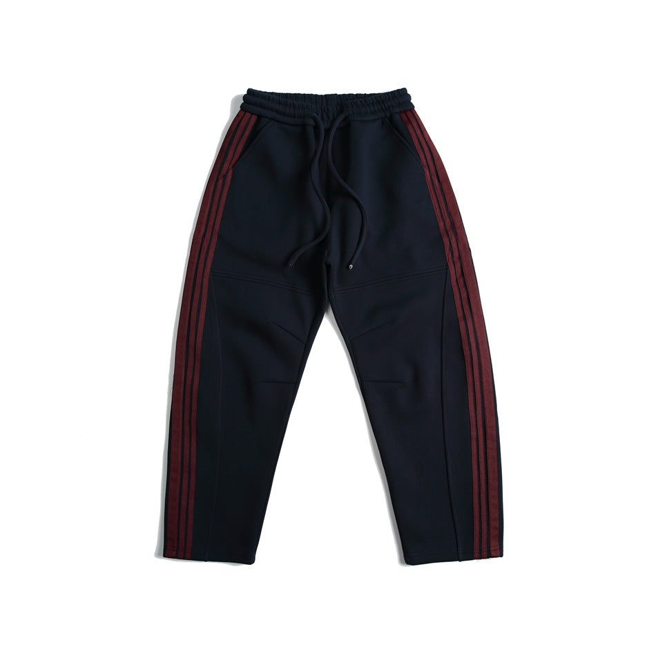 Navy sweatpants with burgundy triple side stripes and drawstring elastic waist, flat lay front view