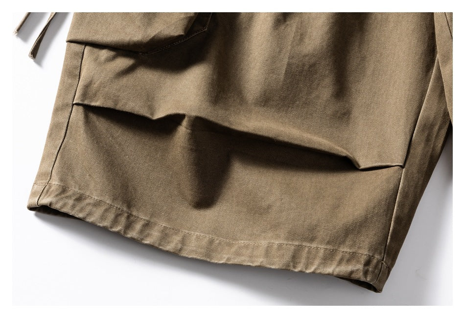 Close-up of a khaki-brown garment hem and large flap pocket.
