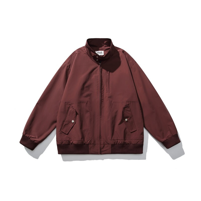 Burgundy zip-up stand-collar jacket flat lay with snap flap pockets, chest pocket and ribbed trim