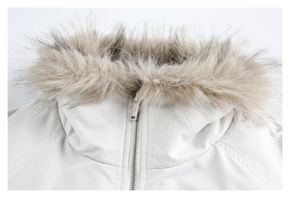 Close-up of a white jacket hood with beige-gray faux-fur trim and a centered zipper.