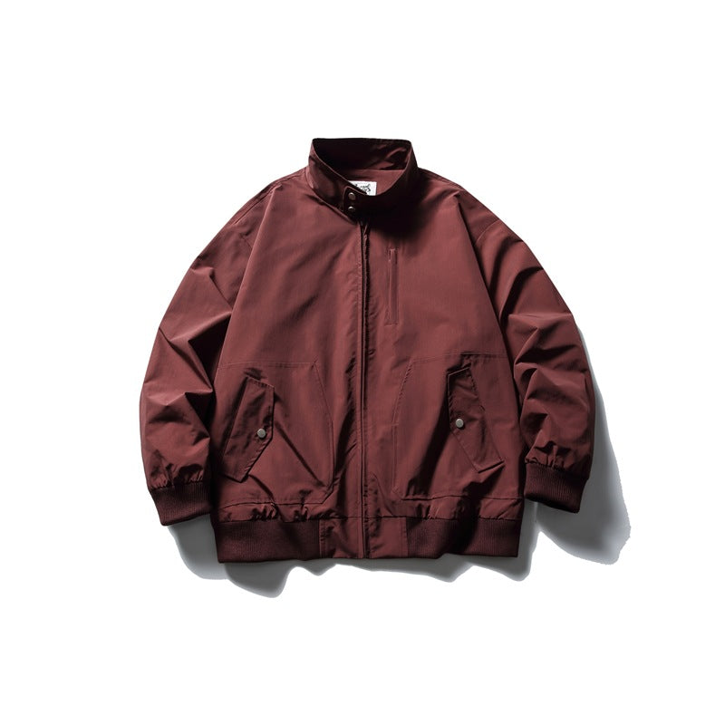 Burgundy stand-collar zip jacket flat lay with snap flap pockets and ribbed cuffs and hem