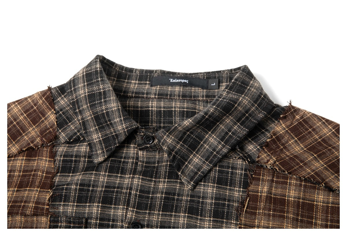 Close-up of a charcoal plaid shirt collar and contrasting brown shoulder panels.