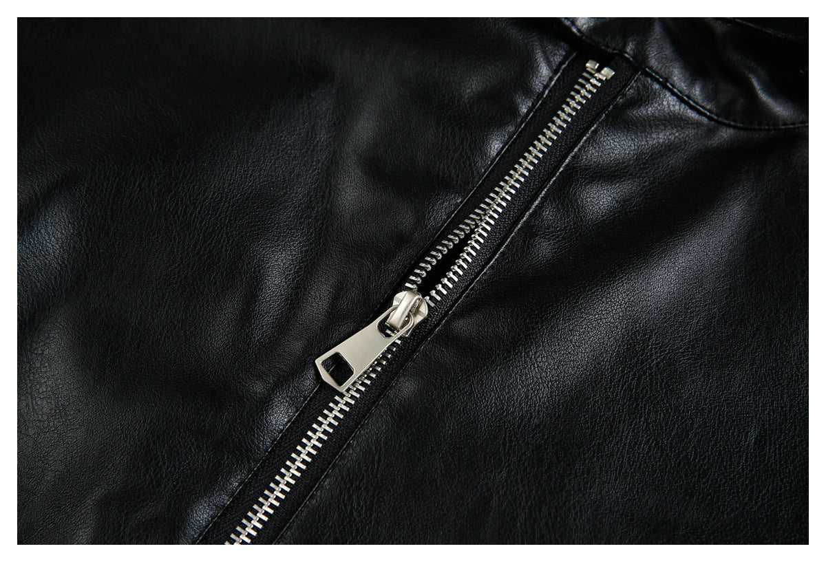 Close-up of a black jacket with a diagonal silver metal zipper.