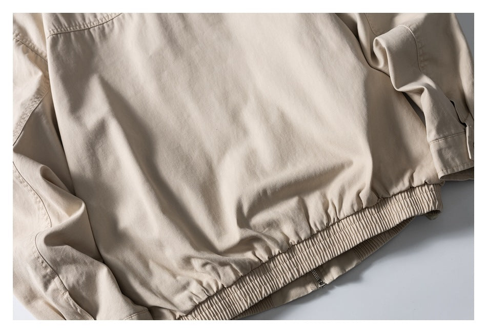 Close-up of a beige garment with a gathered elastic hem and visible stitching.