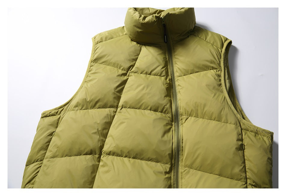 Close-up of the olive-green vest's front zipper, padded collar, quilted panels, and armholes.