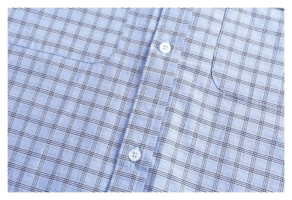 Close-up of the light blue plaid shirt front, showing the button placket and chest pockets.