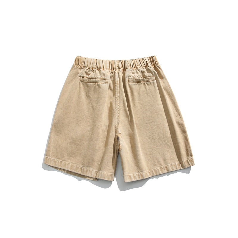 Rear view of light tan shorts with an elastic waistband and two back pockets, displayed flat on white.