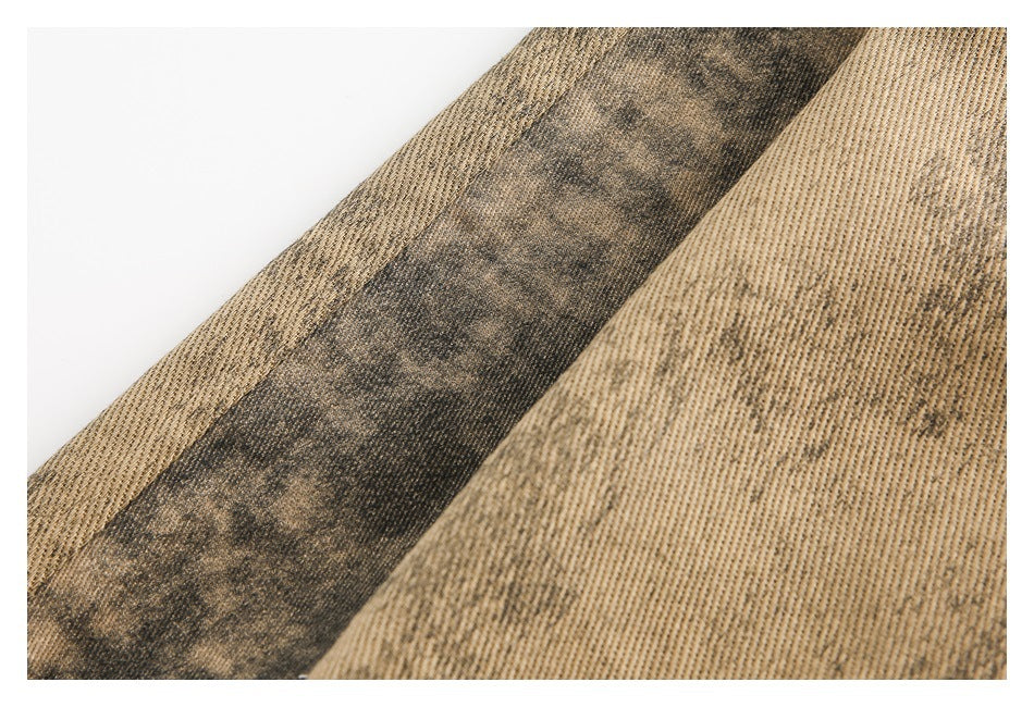 Close-up of tan ribbed fabric panels with a dark mottled stripe between them.