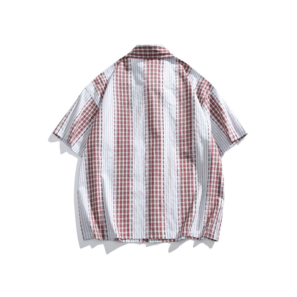 Back view of red plaid and white pinstripe short-sleeve shirt with vertical panels and frayed seams, flat lay