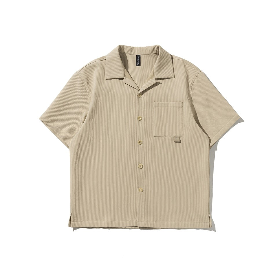 Beige short-sleeve ribbed camp-collar shirt with button front and chest pocket, flat lay front view