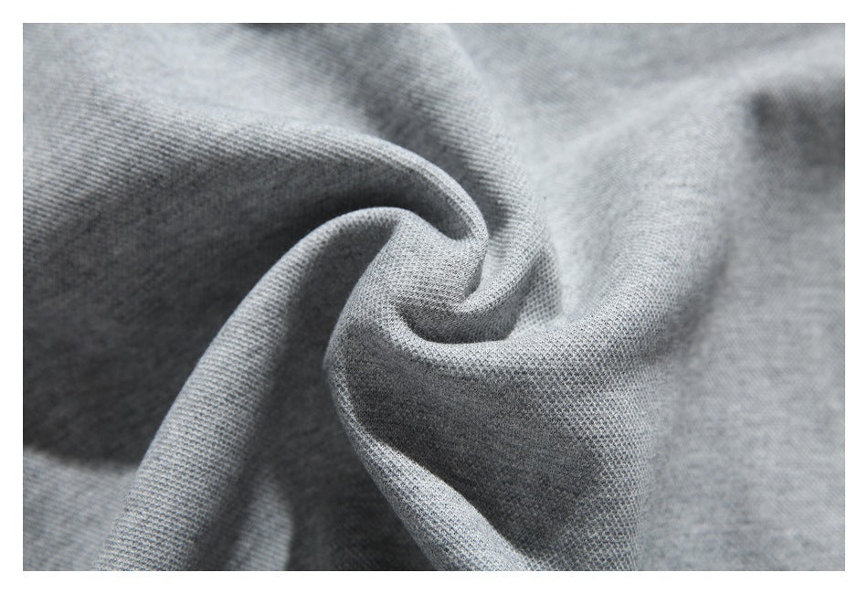 Macro view of the gray sweatshirt's knit fabric gathered into soft folds.