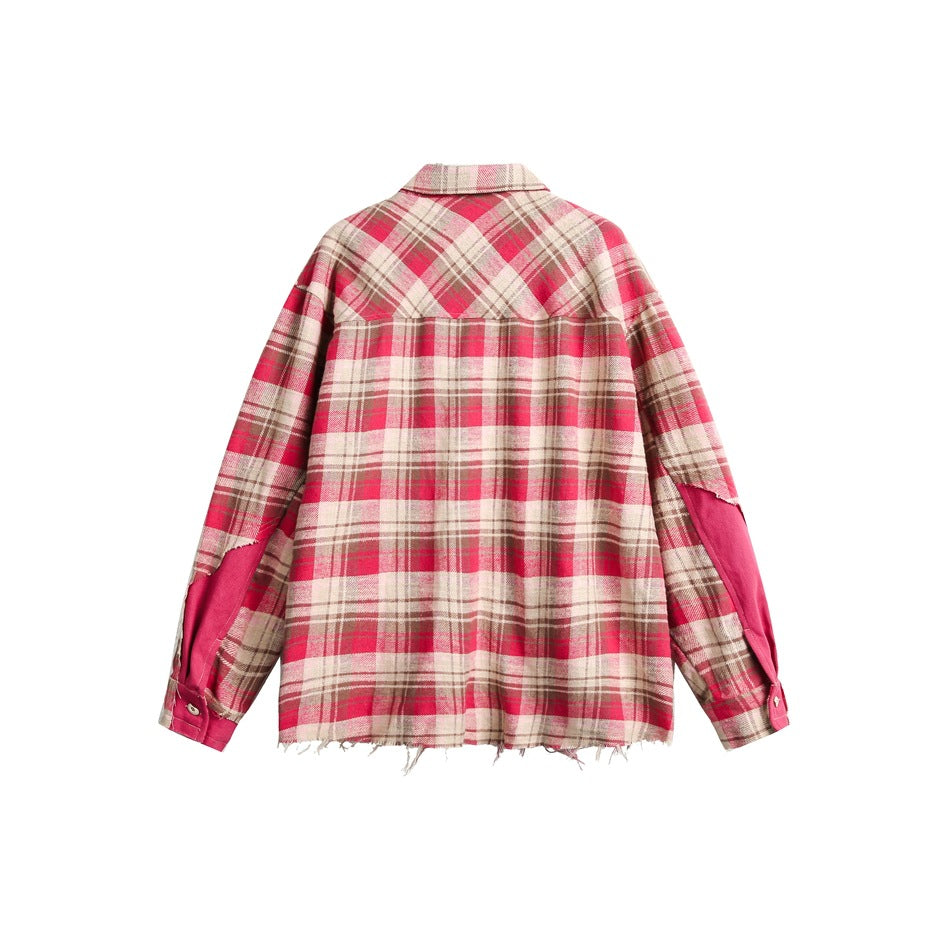 Back view of a red, beige and brown plaid shirt with pink sleeve panels and a frayed hem.