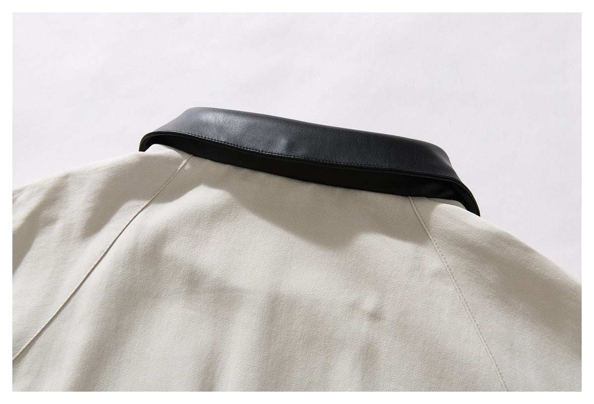 Close-up of the back yoke and wide black collar on an ivory jacket.