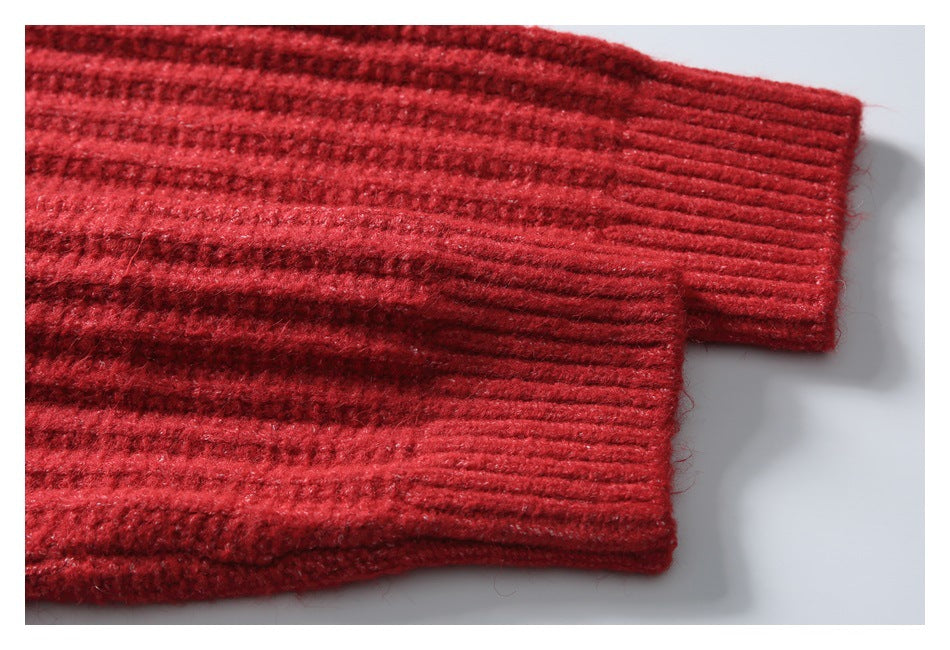 Close-up of a red knit sleeve ending in a wide ribbed cuff.