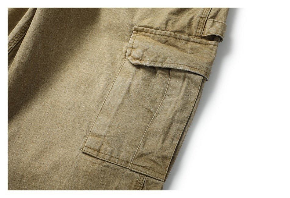 Close-up of a button-flap cargo pocket on tan pants.