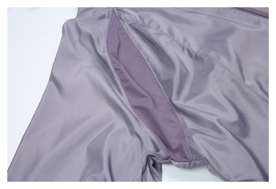 Close-up of a gray-lavender jacket with a darker mesh underarm ventilation panel.