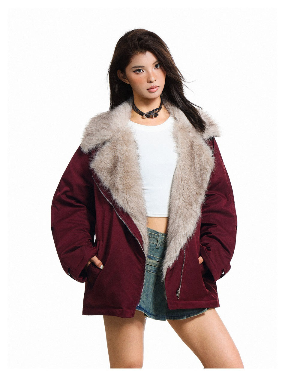Model wearing an open burgundy jacket with an oversized light plush collar and angled zipper.