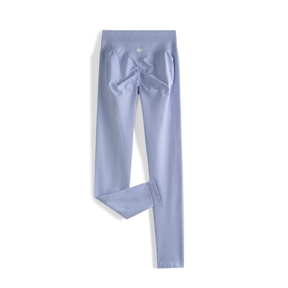 Periwinkle blue high-waisted leggings shown from the back, with a ruched seat and one leg folded to show the hem.