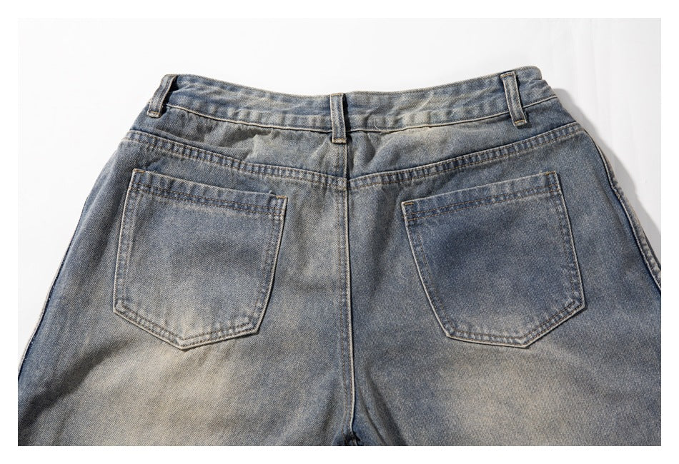 Rear view of faded blue-gray jeans laid flat, showing the waistband, belt loops, yoke, and two back pockets.